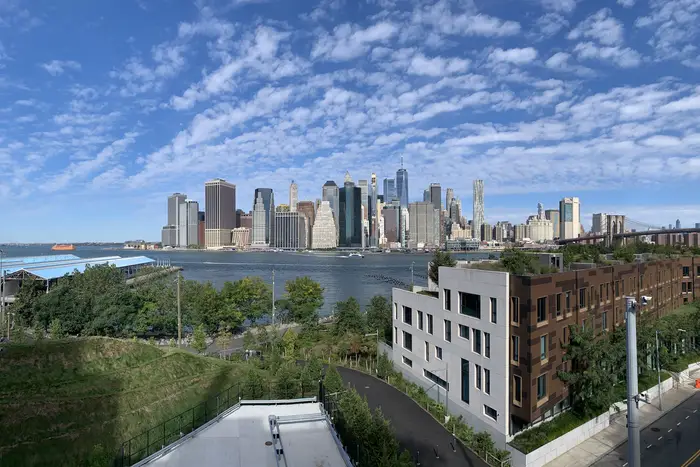 A view of the lower Manhattan skyline and the East River from Brooklyn Heights on a sunny morning.